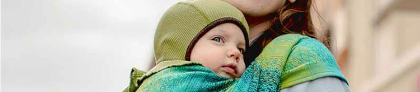 A picture of a baby being carried in a Didymos Ada Malachite Woven Wrap